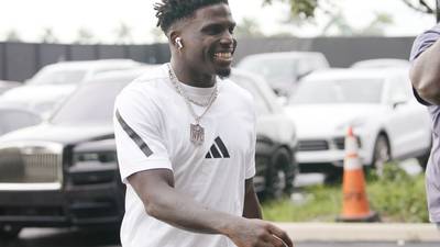 Tyreek Hill smiles and waves as he arrives at Hard Rock Stadium for Dolphins' game against Bills