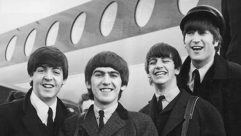 The Beatles, left to right, Paul McCartney, George Harrison, Ringo Starr and John Lennon (1940 - 1980) arrive at London Airport February 6, 1964, after a trip to Paris.